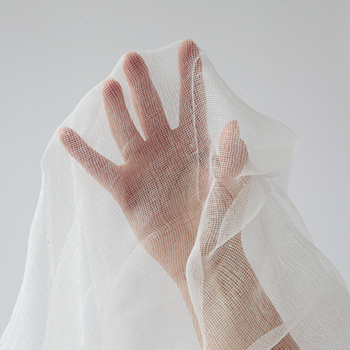 Hand covered by cheescloth