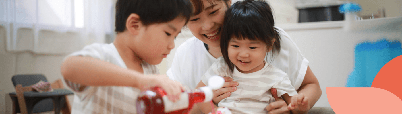 Parent and two children baking together