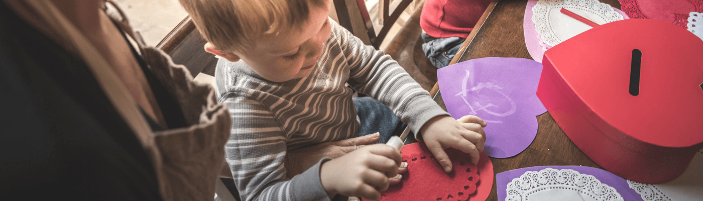 Parent and child crafting a valentine together